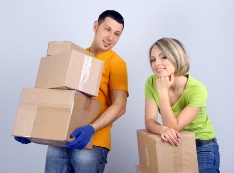Removal crew handling furniture in a Westcombe Park property